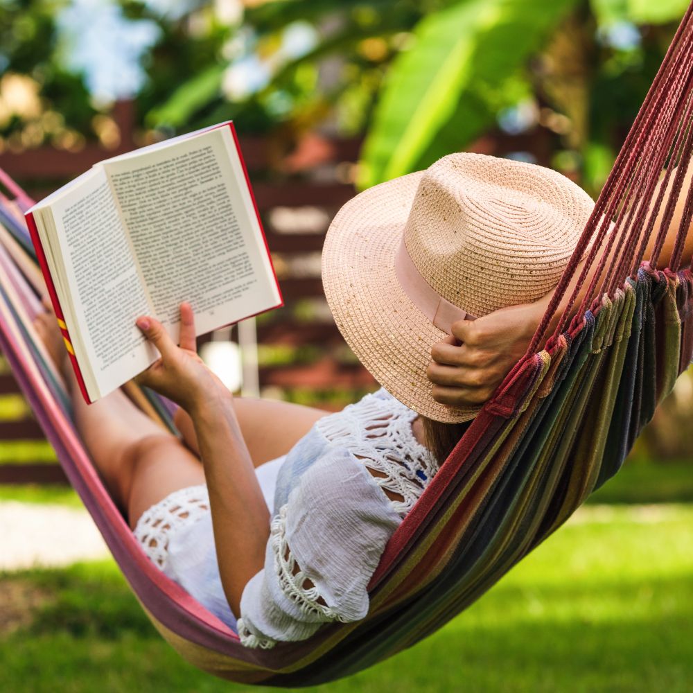 30 Summer Bucket List Ideas That Feel Like Everything (Low Key, Low Cost) 3 woman reading in hammock in backyard