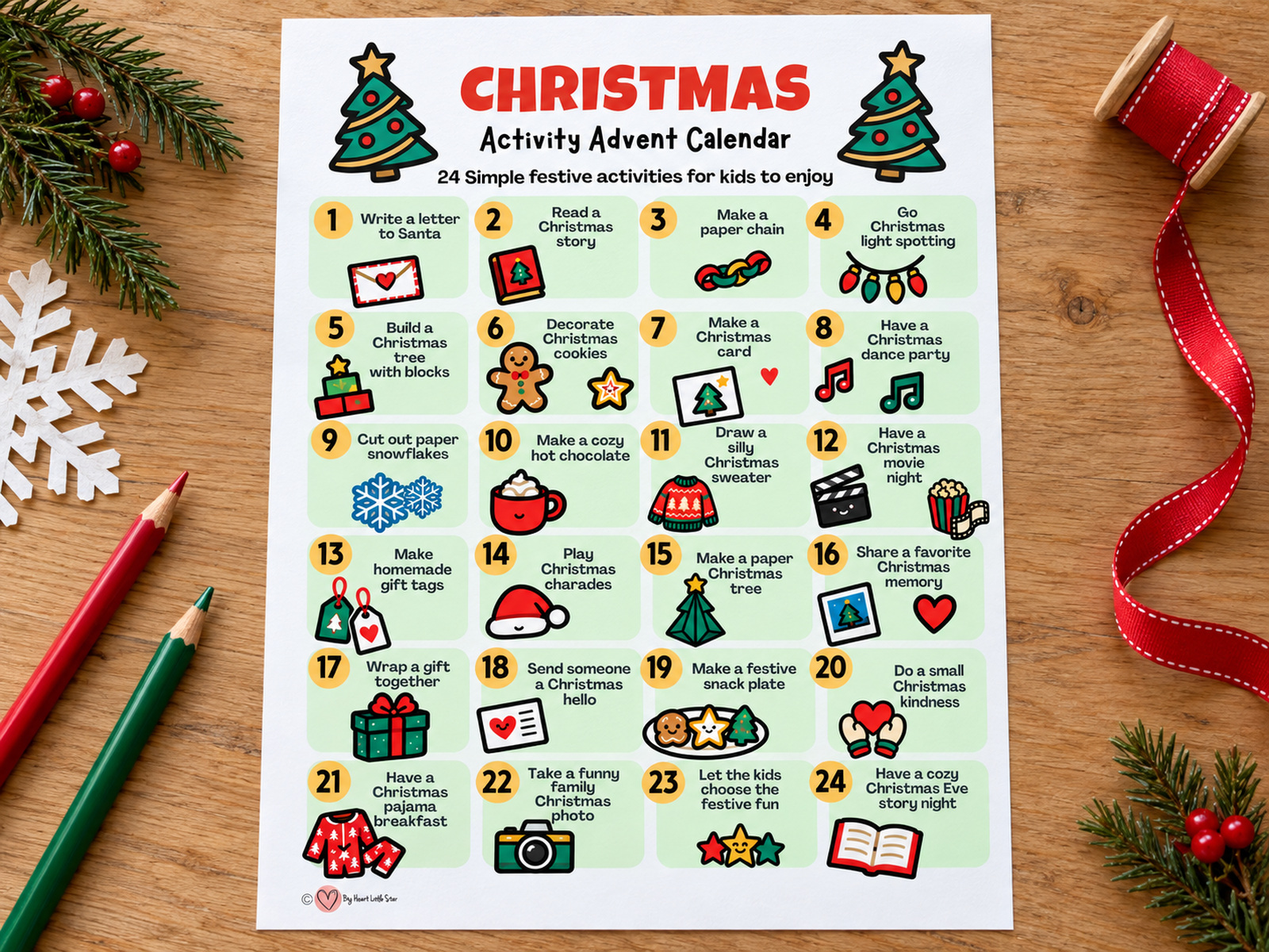 Christmas Activity Advent Calendar printable on a wooden table with colored pencils, red ribbon and evergreen sprigs